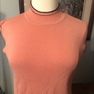Peach sweater with black trim